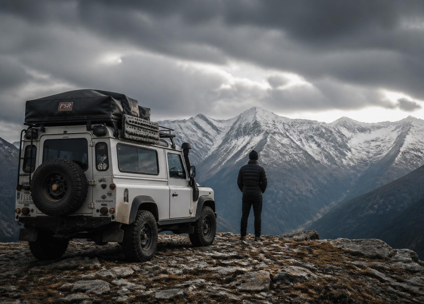 Expedition vehicle parked overlooking remote mountains